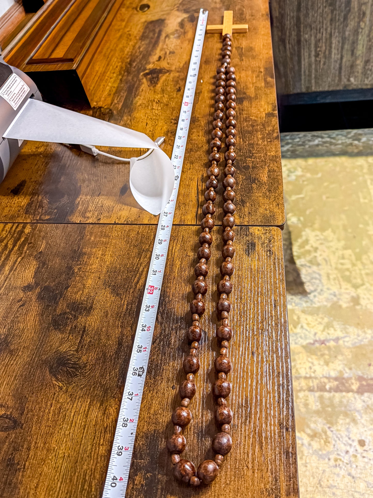 Close-up of deep burgundy wood beads showing mottled organic grain and spacer beads