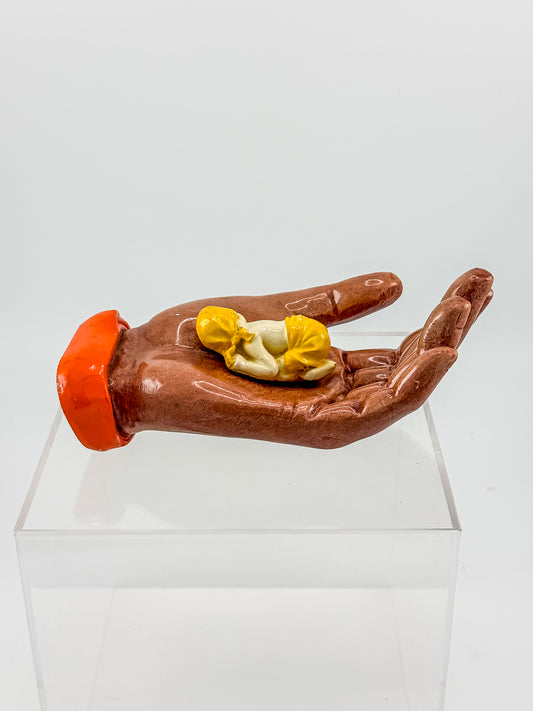 Ceramic Hand Sculpture with Sleeping Figure and Orange Cuff - Possibly Religious