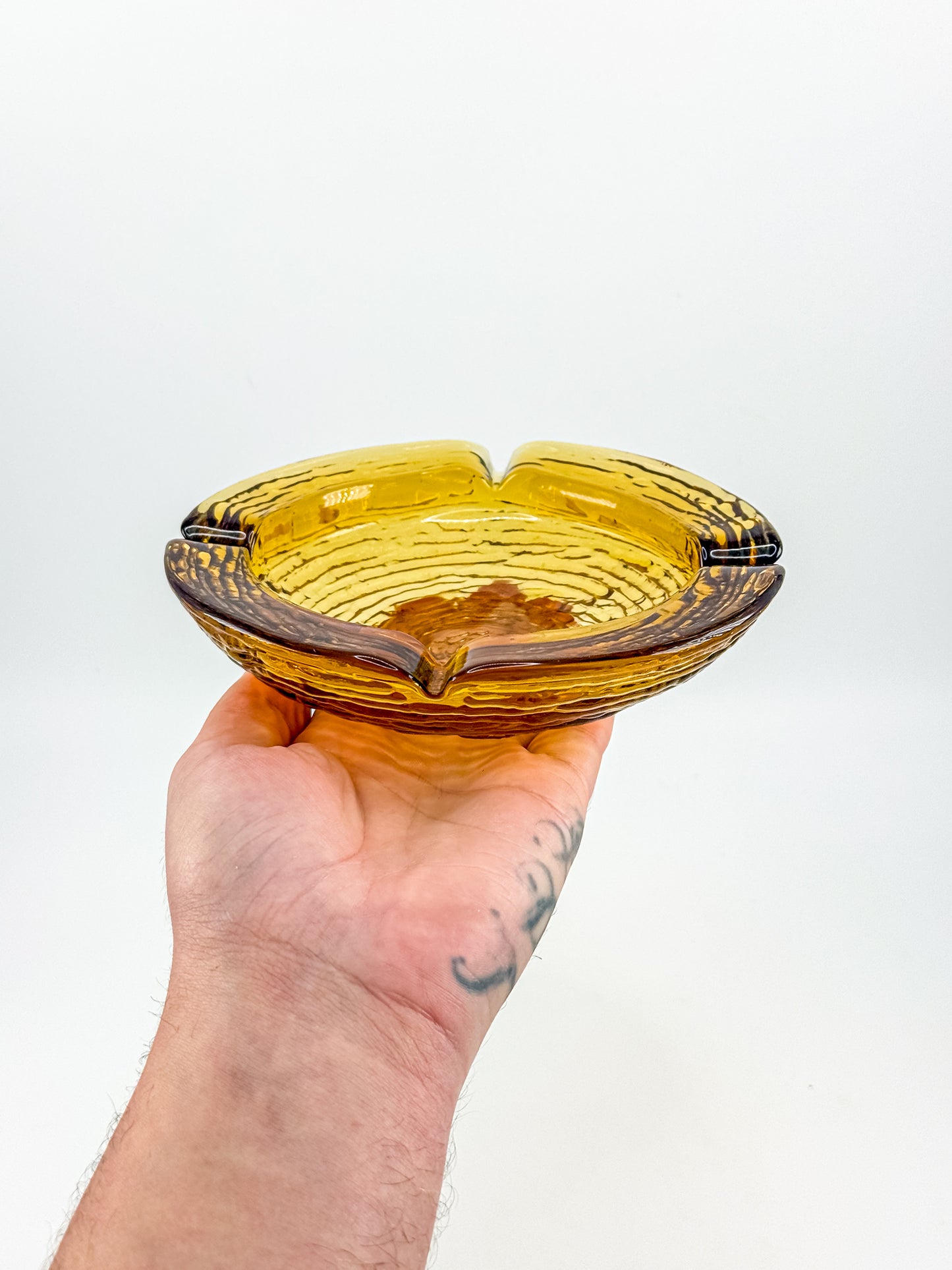 Vintage Anchor Hocking Soreno Amber Glass Ashtray with Concentric Bark Texture and Four Cigarette Rests