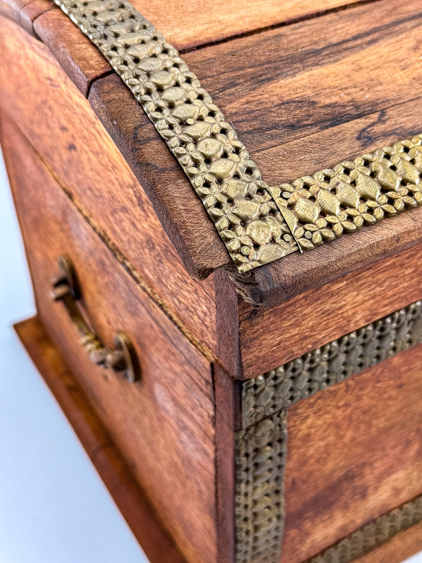 Side view of vintage Indian brass-inlay dome-top wooden chest with ruler showing approx. 9 inch height