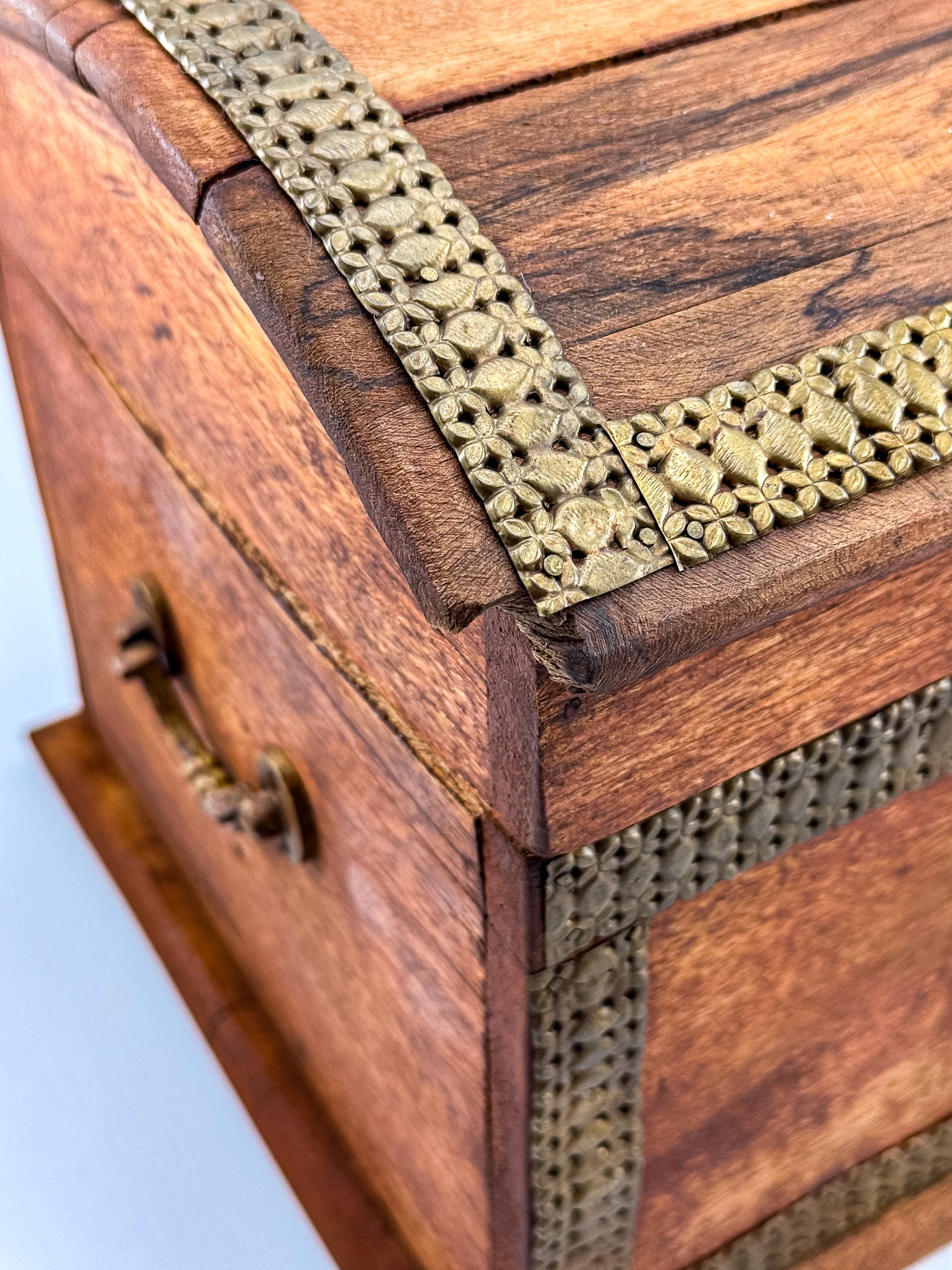 Side view of vintage Indian brass-inlay dome-top wooden chest with ruler showing approx. 9 inch height