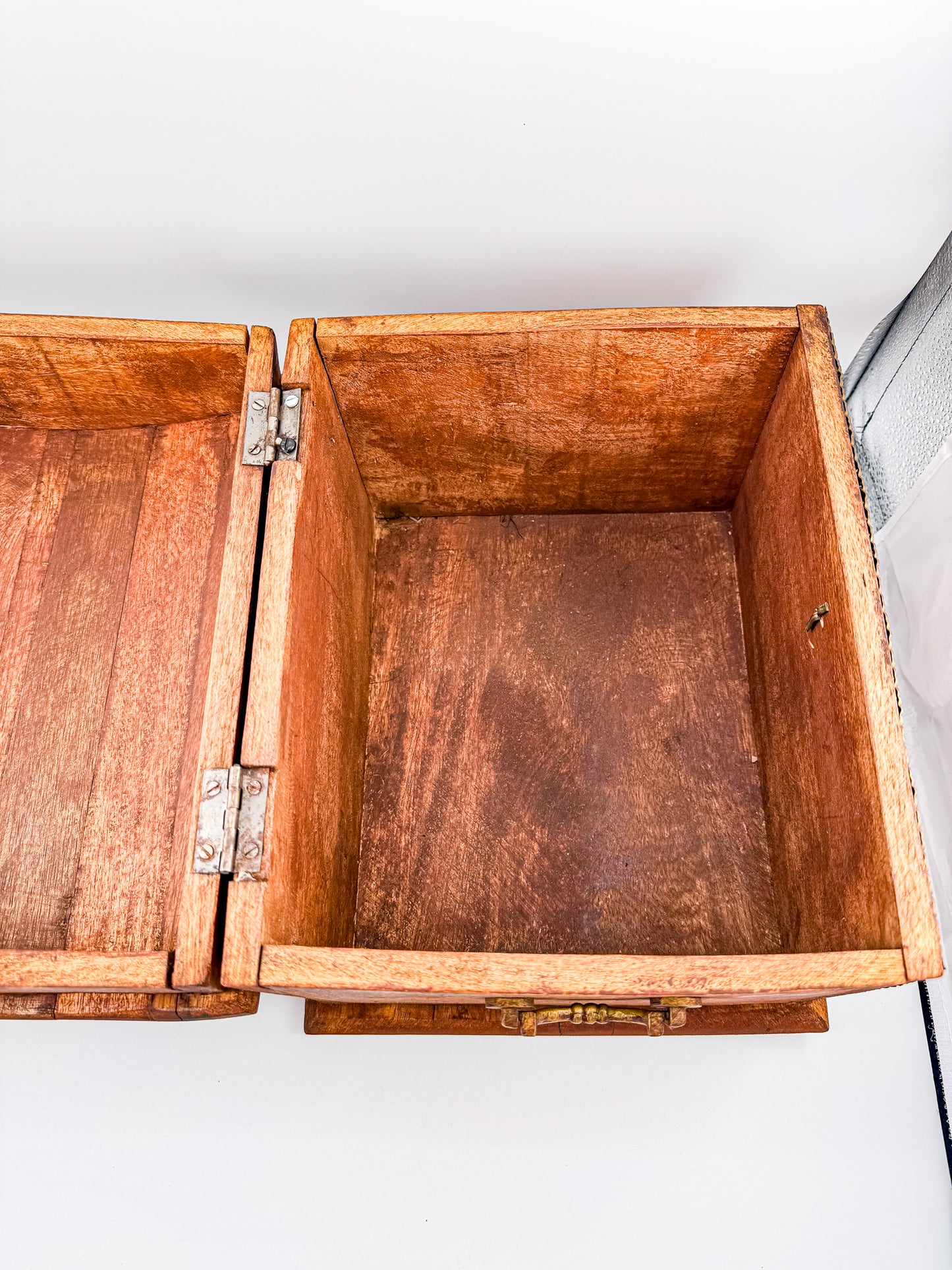 Back view of vintage Indian brass-inlay dome-top wooden treasure chest with ruler showing approx. 8 inch depth