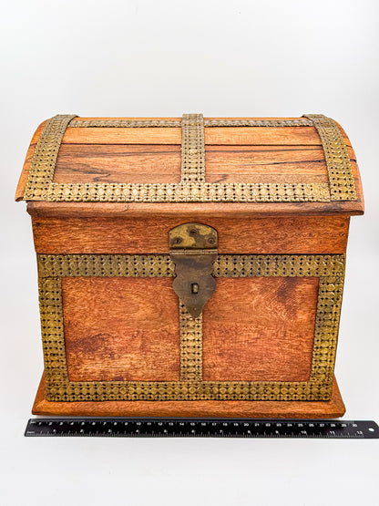 Top view of vintage Indian brass-inlay dome-top wooden chest showing brass cross banding on lid