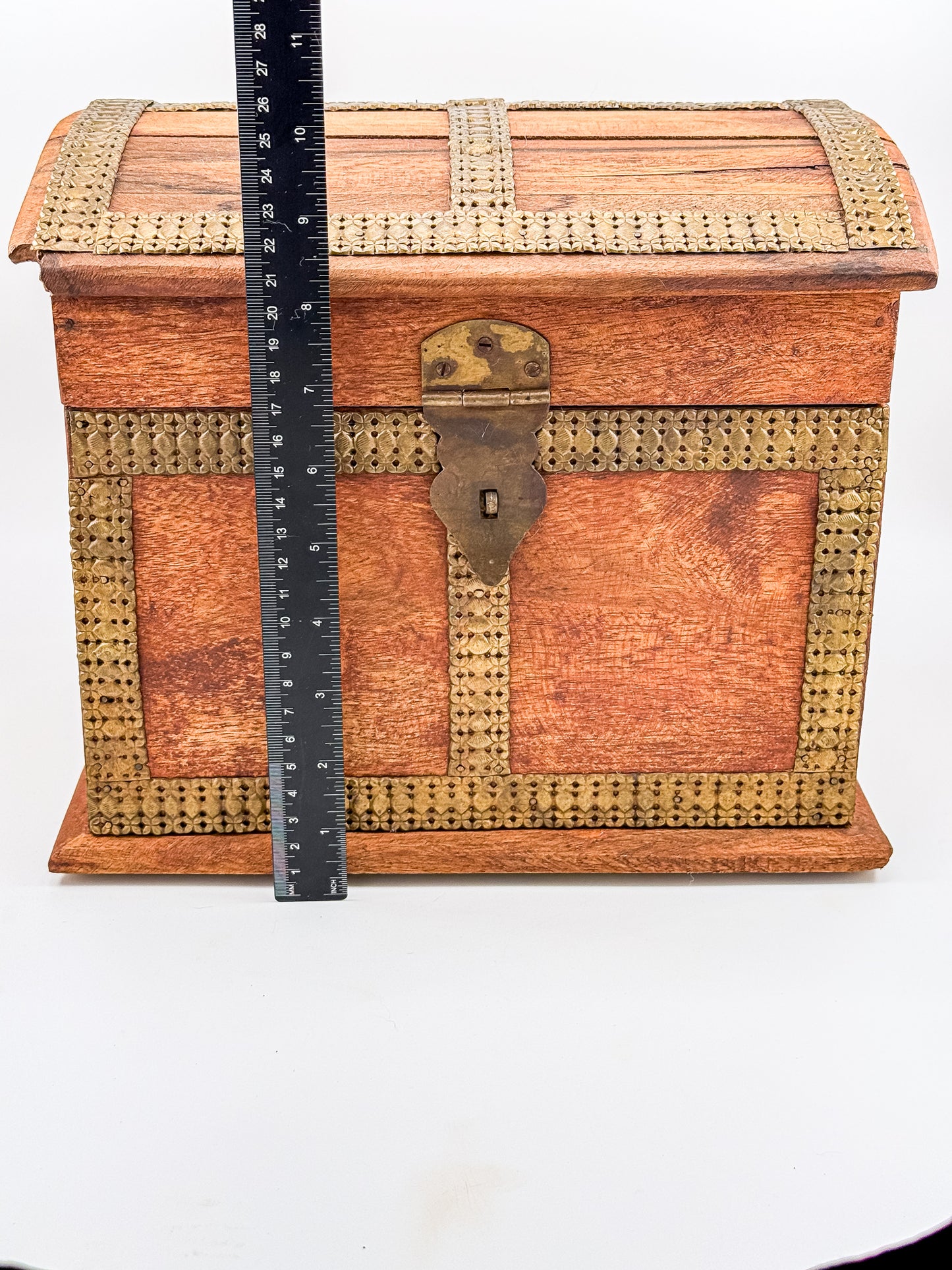 Close-up of working brass front clasp on vintage Indian dome-top wooden treasure chest