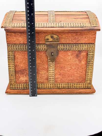 Close-up of working brass front clasp on vintage Indian dome-top wooden treasure chest