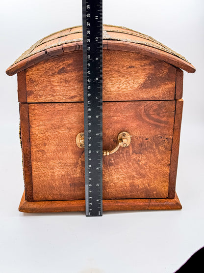 Close-up of chipped corner on vintage Indian brass-inlay wooden chest showing condition
