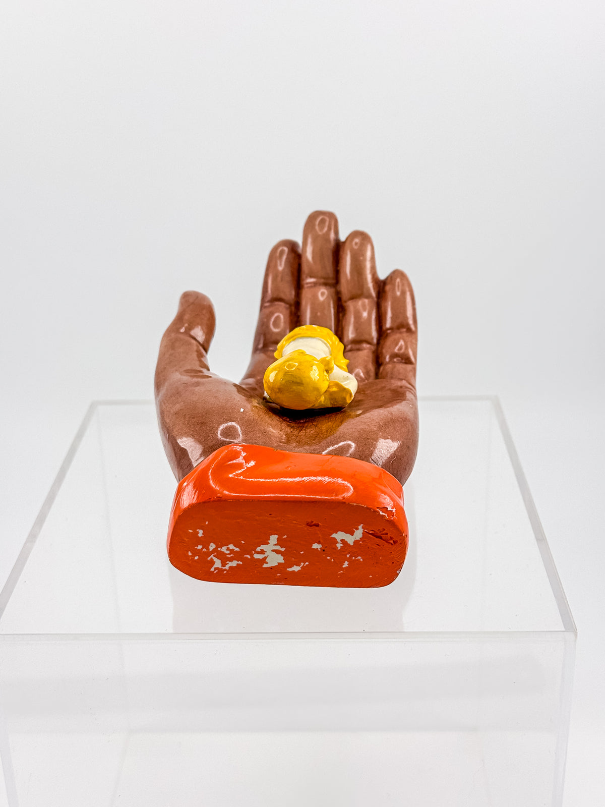 Ceramic Hand Sculpture with Sleeping Figure and Orange Cuff - Possibly Religious